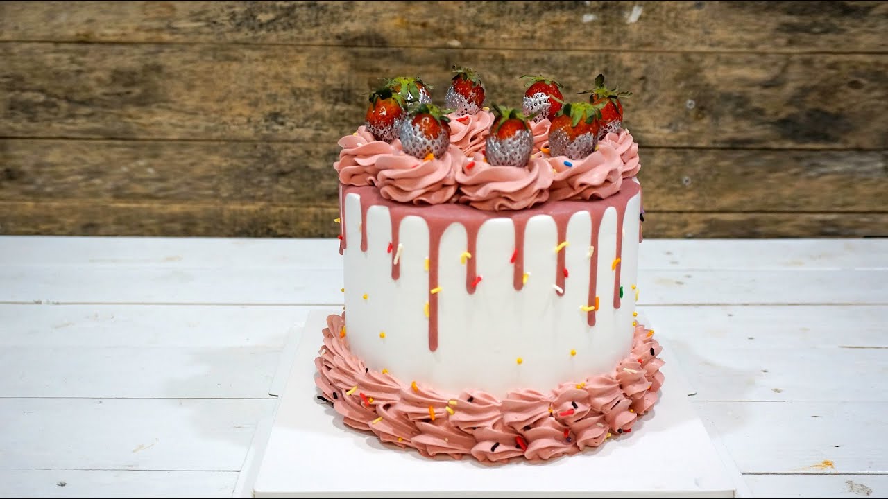 Video thumbnail for Pink cream drip cake decoration with strawberry