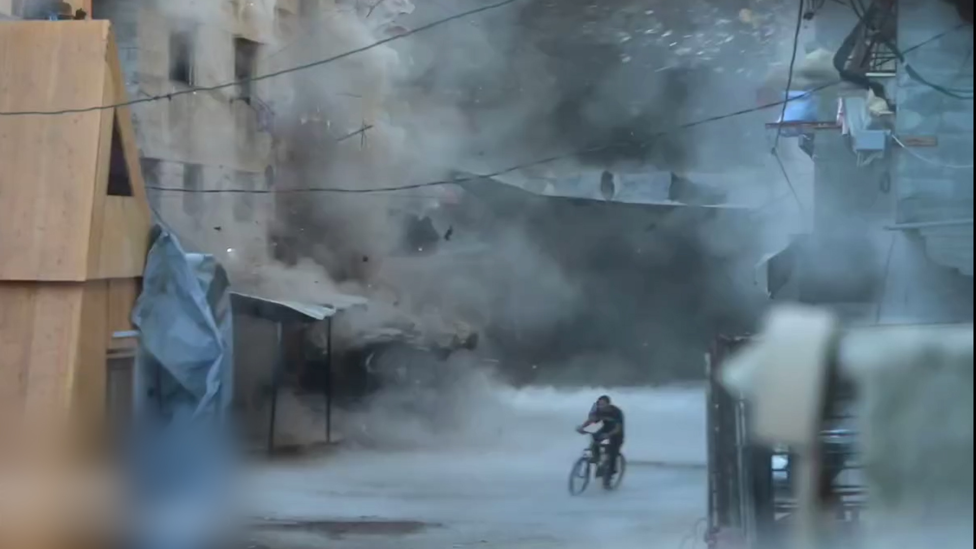 'Video thumbnail for Palestinian on bike tries to flee falling debris in Gaza from Israeli strike'